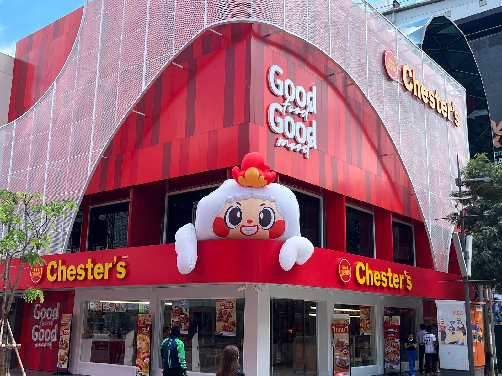 A Chester’s chicken restaurant with a giant chicken mascot on its red facade in Siam Square