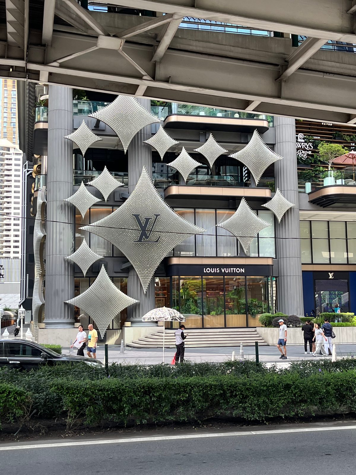 Giant silver star sculptures across the front of a Louis Vuitton store at Ratchaprasong