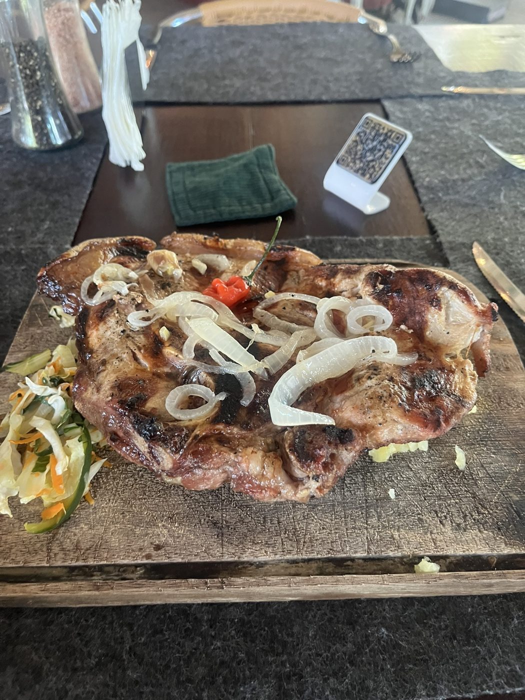 Grilled pork served on a wooden board at a Havana paladar