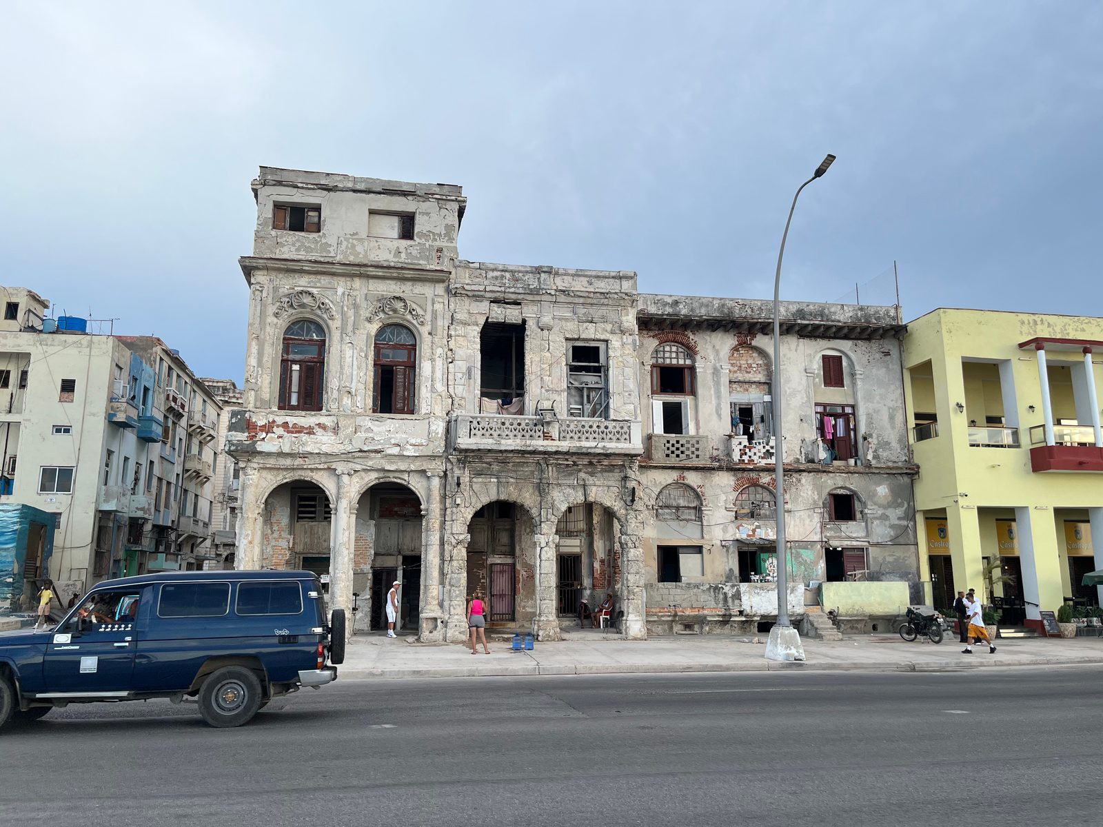 Weathered colonnaded buildings facing the Malecón