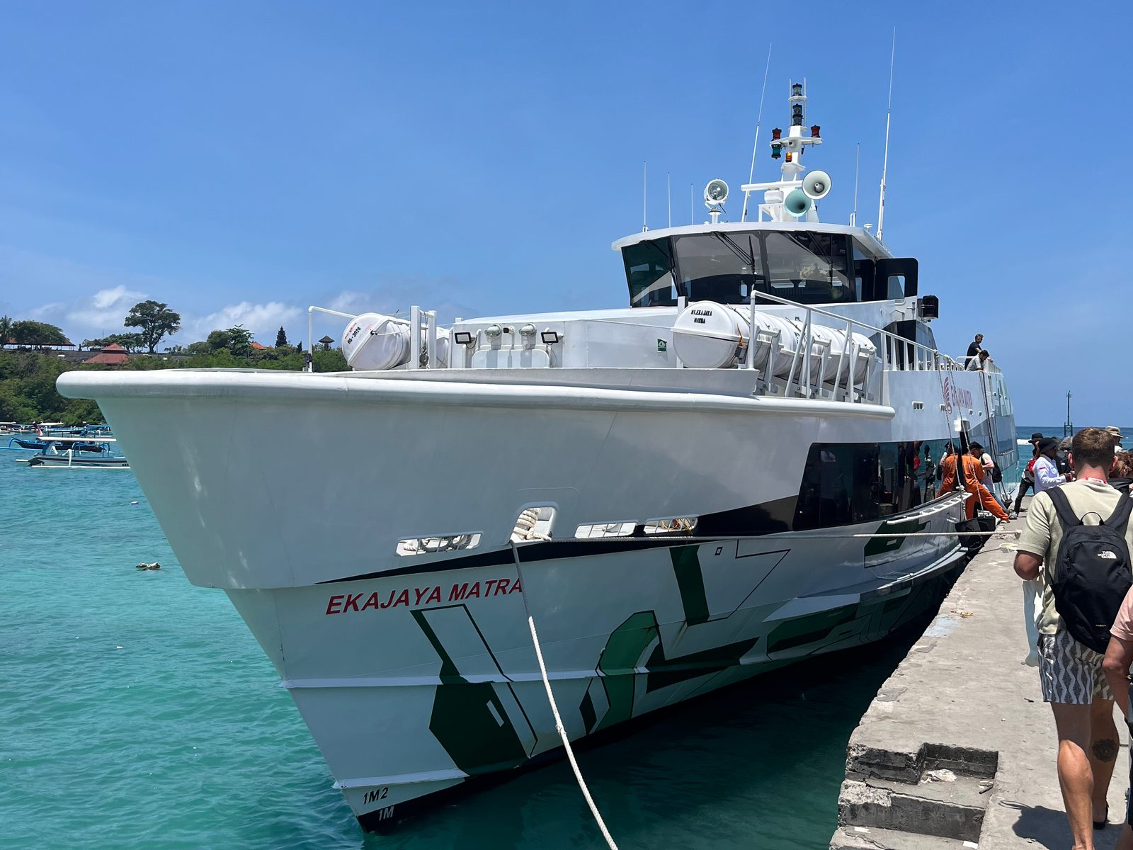 A white fast boat moored at the pier in Padang Bai harbour