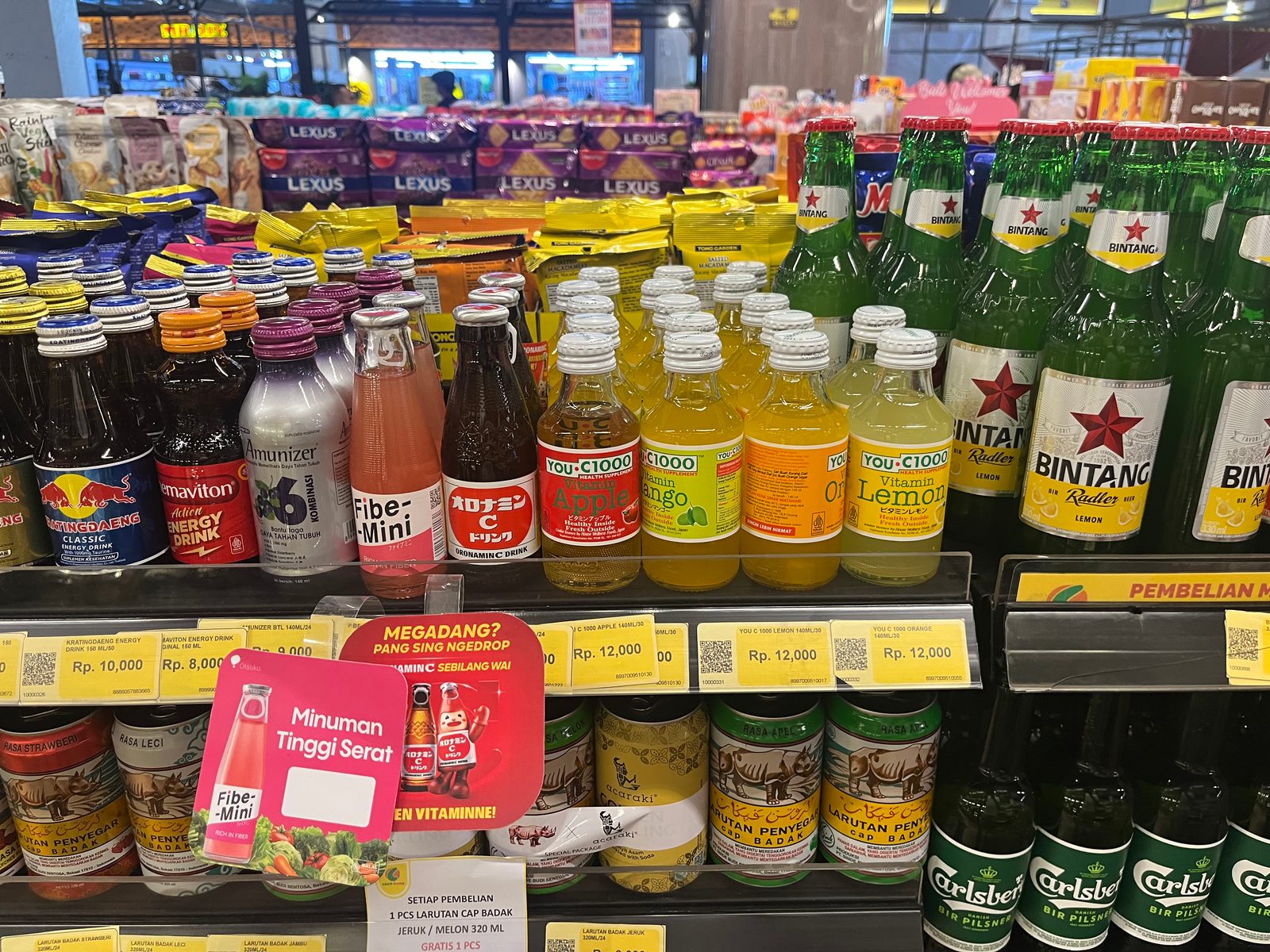 Drinks on a supermarket shelf with rupiah price tags