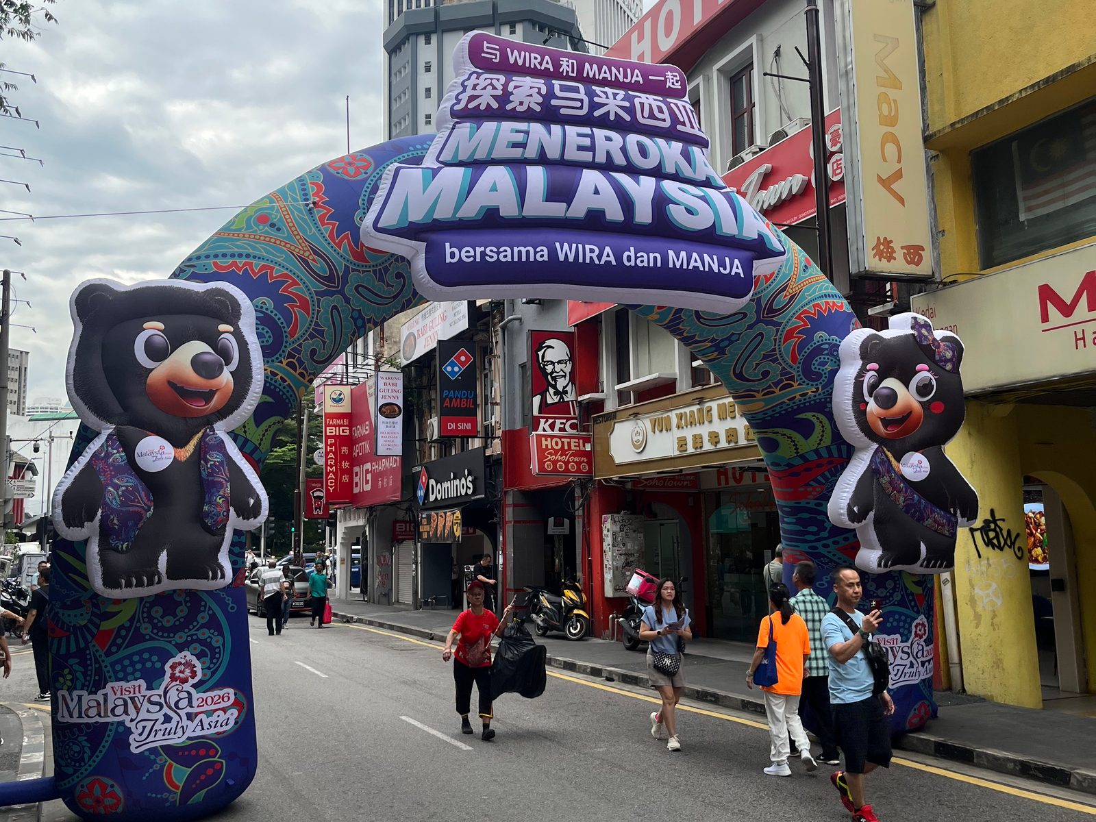 Inflatable Visit Malaysia 2026 arch with two bear mascots over a street in Kuala Lumpur’s Chinatown