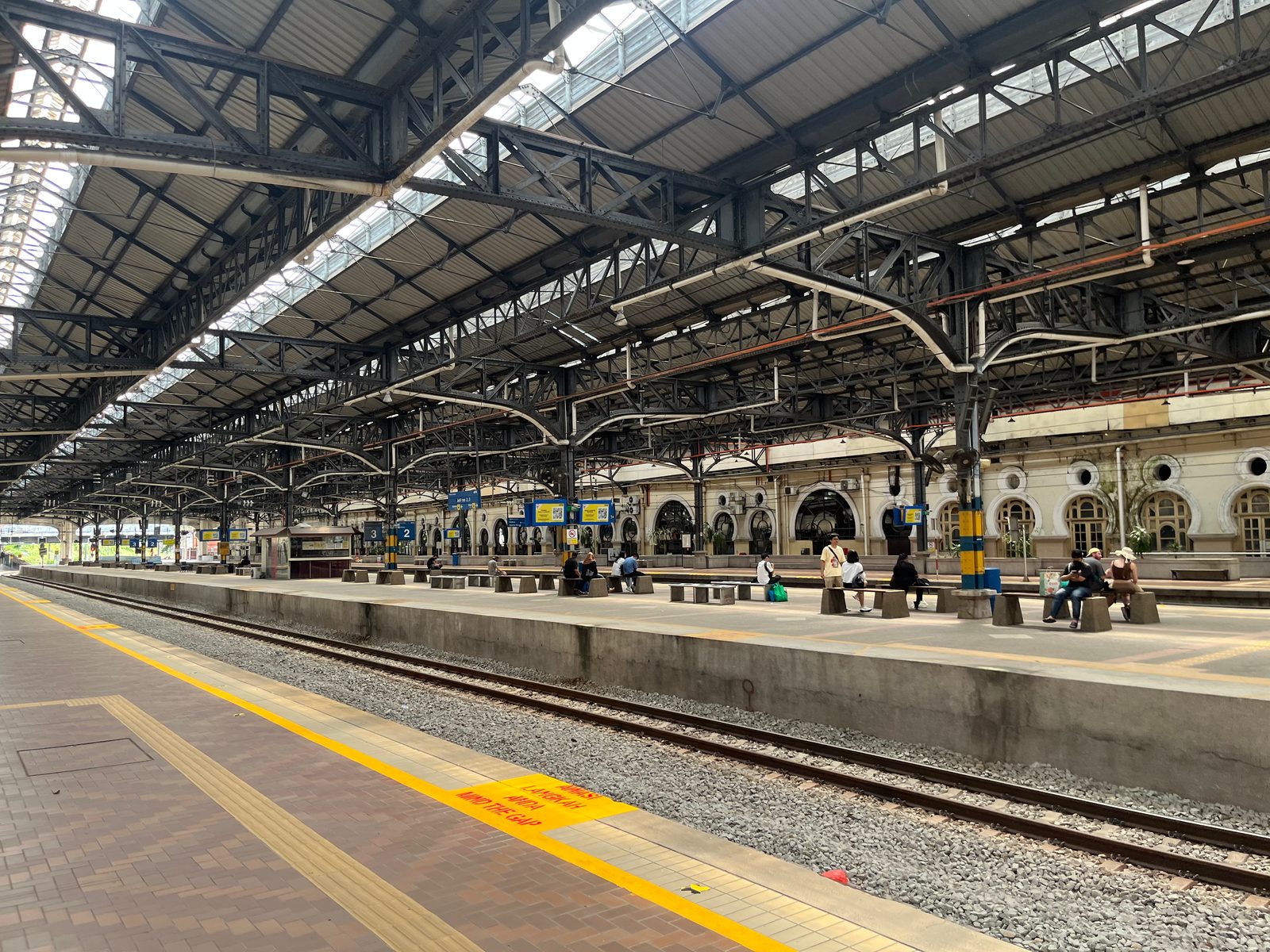 Platforms of Kuala Lumpur's old railway station under a long steel canopy
