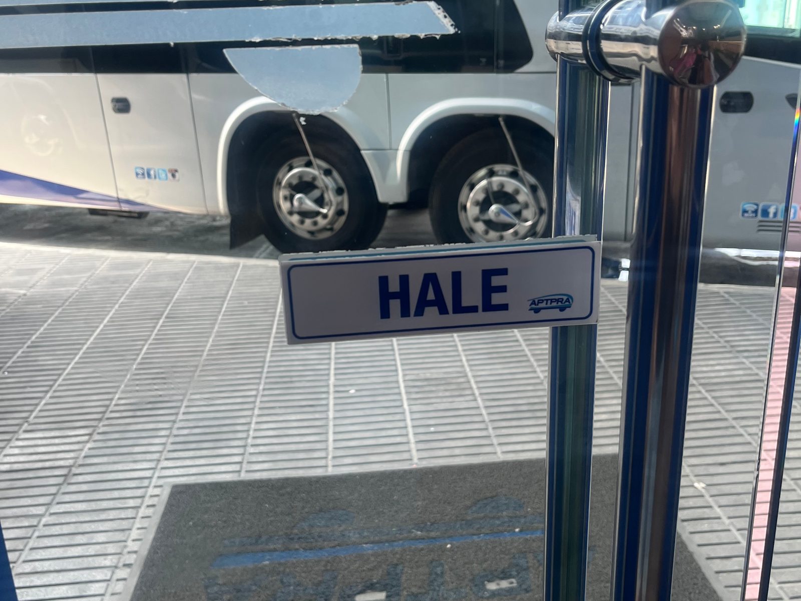 Intercity coach seen through the glass door of the bus terminal in Bávaro