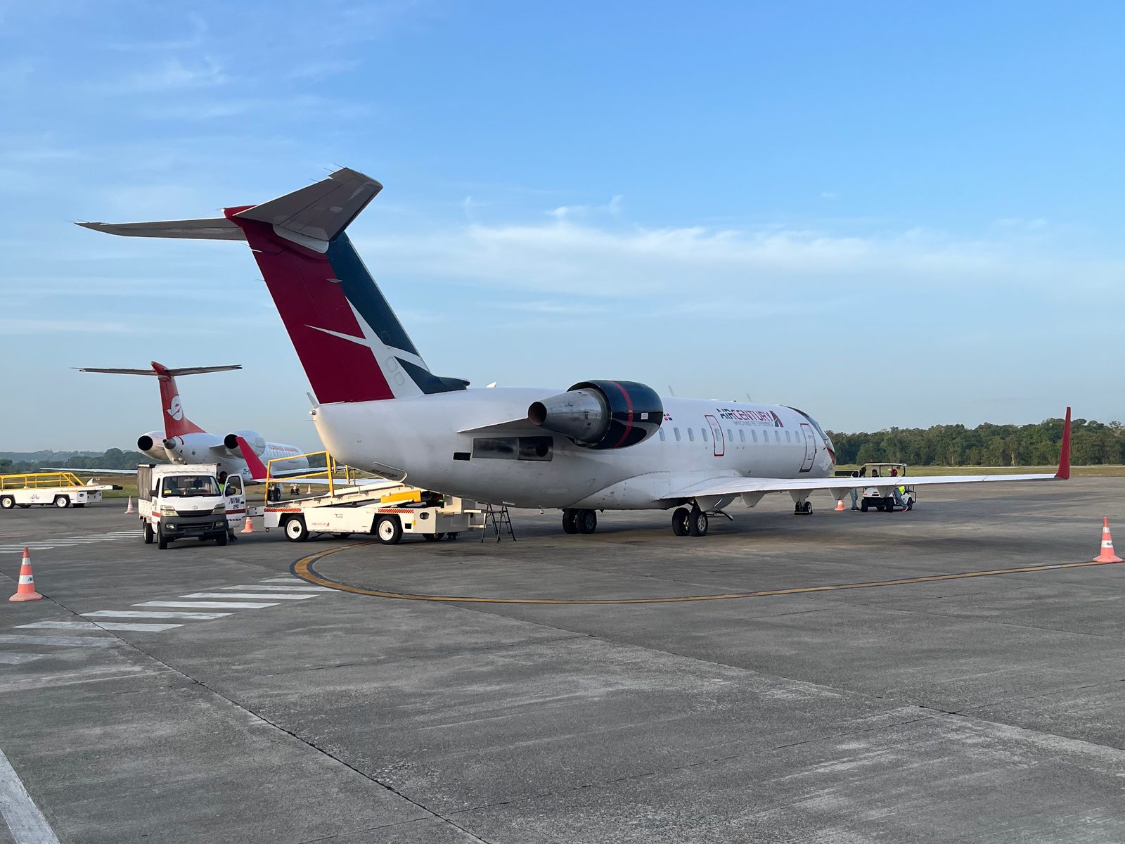 Regional jet parked on the apron at La Isabela airport in the early morning